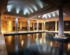Indoor heated pool with lounge area at Alexander House Hotel And Utopia Spa Hotel.