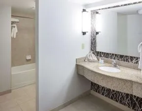 Guest bathroom with shower and tub at Hilton Garden Inn Nashville Vanderbilt.