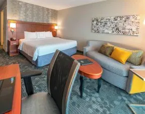 Day use room with work desk and sofa at Courtyard By Marriott Montgomery Prattville.