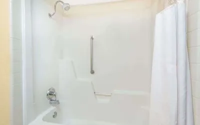 Guest bathroom with shower and tub at Blue Way Inn & Suites Wichita East.