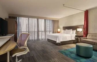 Spacious day use room with work desk and sofa at Home2 Suites By Hilton Chicago River North.