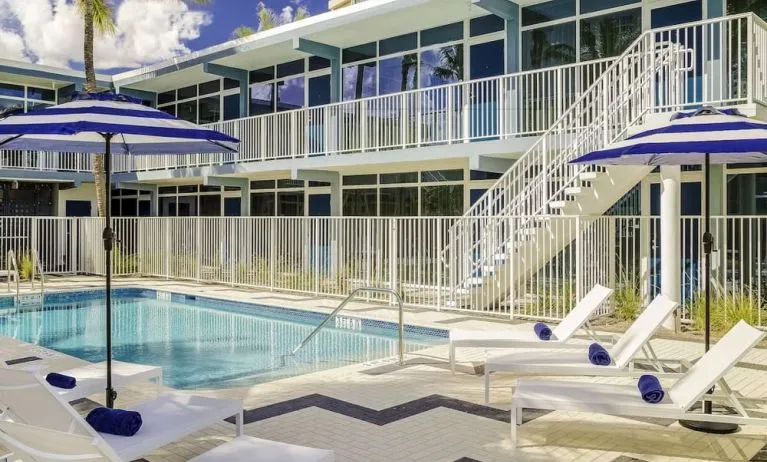 Refreshing outdoor pool and sun loungers at Plunge Beach Resort.