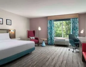 Bright and spacious day use room with work desk and lounge seating at Hilton Garden Inn Kennett Square.