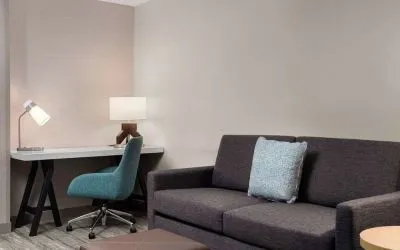 Day use room with workspace and lounge seating at Hilton Garden Inn Kennett Square.