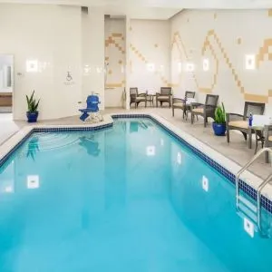 Indoor pool with lounge chairs at Hilton Garden Inn Washington DC Downtown.