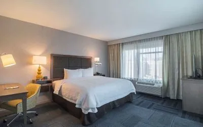 King bed with work desk at Hampton Inn Chicago North/Loyola Station.