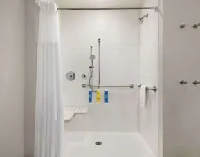 Guest bathroom with shower at Tru By Hilton Milwaukee Brookfield.