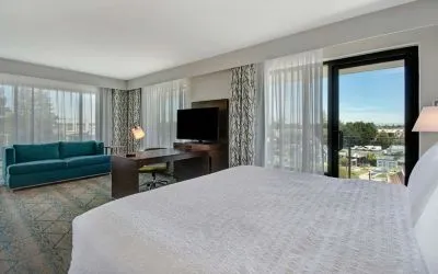 Day use room with work desk, sofa and balcony at Hampton Inn & Suites Sunnyvale Silicon Valley.