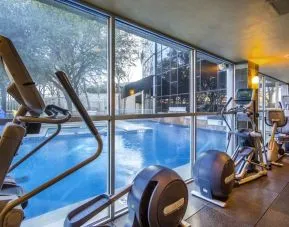 Fitness center overlooking the pool at Hilton Dallas Lincoln Centre.