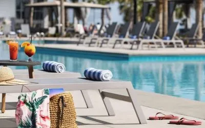Sun loungers surrounding the pool at Embassy Suites By Hilton Myrtle Beach Oceanfront Resort.