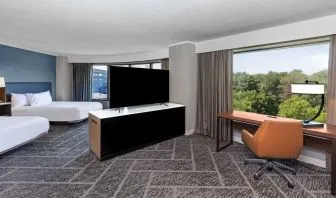 Two queen beds in a spacious day use room with work desk at DoubleTree By Hilton Tulsa - Warren Place.