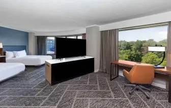 Two queen beds in a spacious day use room with work desk at DoubleTree By Hilton Tulsa - Warren Place.