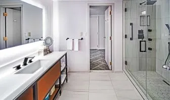 Guest bathroom with shower at DoubleTree By Hilton Tulsa - Warren Place.