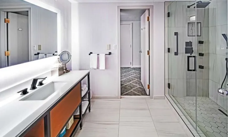Guest bathroom with shower at DoubleTree By Hilton Tulsa - Warren Place.
