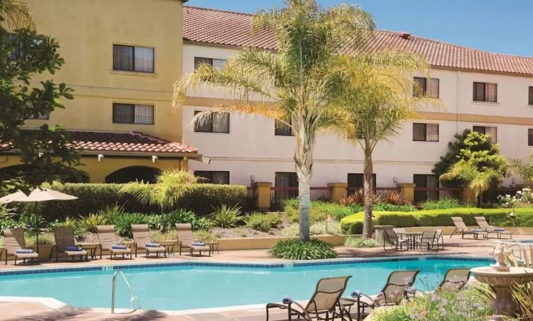 Refreshing outdoor pool surrounded by sun loungers at DoubleTree By Hilton Sonoma Wine Country.