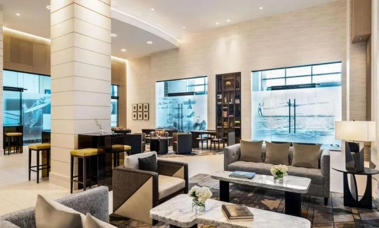 Hotel lobby with comfortable seating at Hilton BNA Nashville Airport Terminal.
