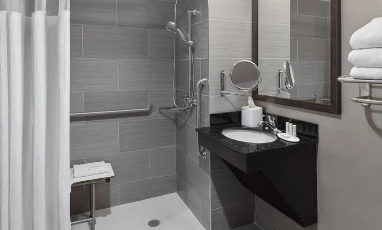 Ptivate guest bathroom with shower at Fairfield Inn & Suites By Marriott New York Staten Island.