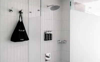 Private guest bathroom with shower and free toiletries at Arlo SoHo.