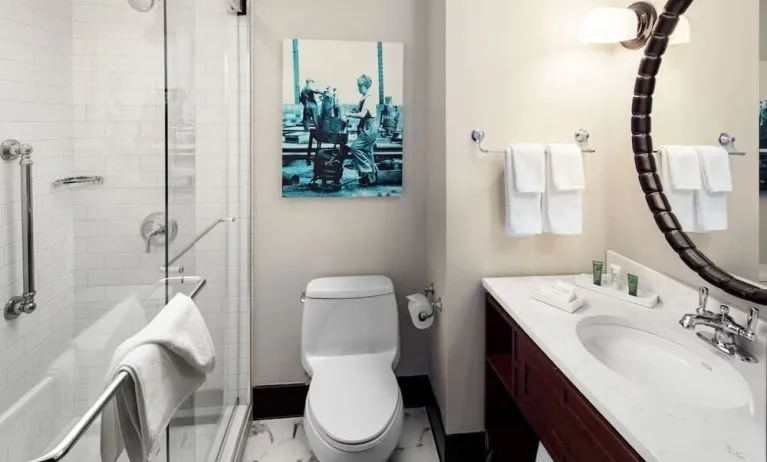 Private guest bathroom with shower and free toiletries at Hilton Brooklyn New York.