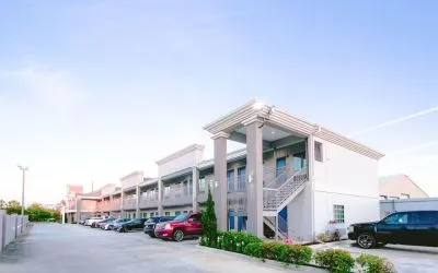 Hotel exterior and parking area at Express Inn - Spring.