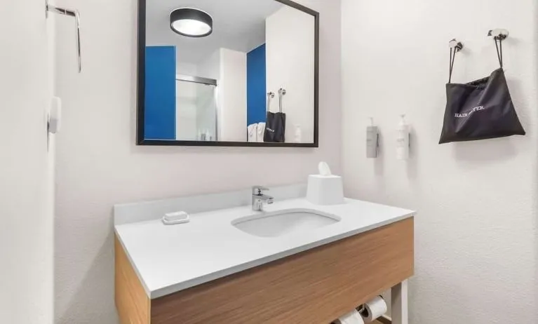 Private guest bathroom with shower and free toiletries at Spark By Hilton Pearland.