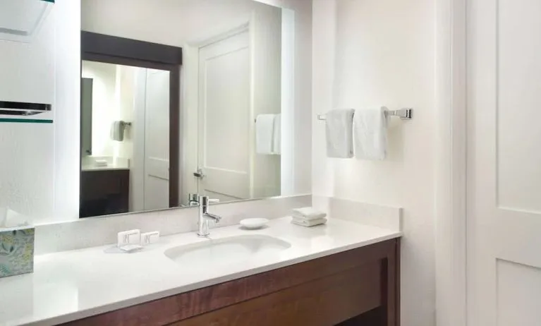 Private guest bathroom with shower and free toiletries at Sonesta ES Suites Raleigh Cary 