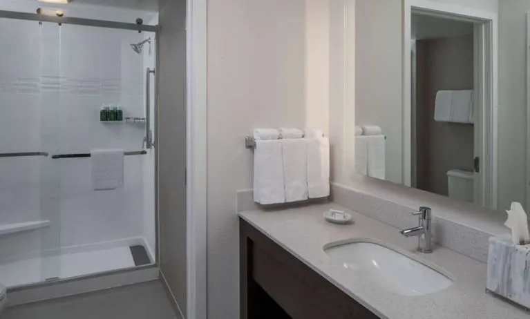 Private guest bathroom with shower and free toiletries at Sonesta ES Suites Fairfax Fair Lakes.
