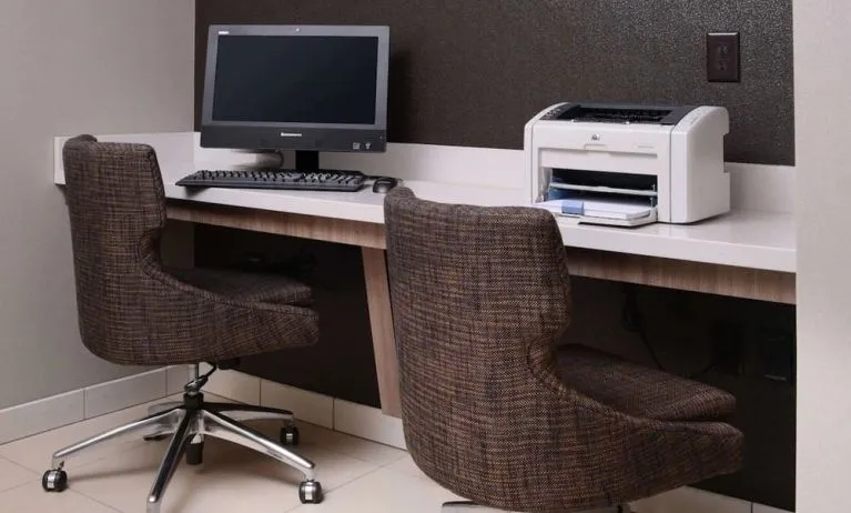 Business center with computer, printer and comfortable seating at Sonesta ES Suites Dallas Medical Market Center.