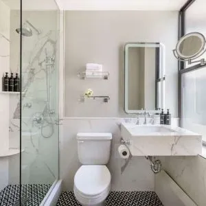 Private guest bathroom with shower at The Benjamin Royal Sonesta New York.