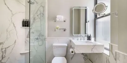 Private guest bathroom with shower at The Benjamin Royal Sonesta New York.