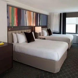 Day use twin room with lounge area at The Fifty Sonesta Select New York.