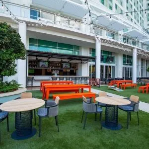 Alfresco dining and lounge area beside a bar at Hilton Orlando.