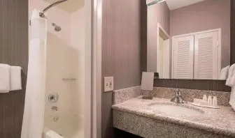 Private guest bathroom with shower and free toiletries at Sonesta Select Tempe Downtown.