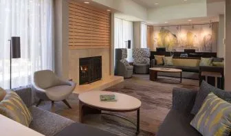 Lobby lounge with comfortable seating and fireplace at Sonesta Select Pleasant Hill.