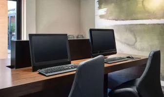Business center with computers and ergonomic chairs at Sonesta Select Phoenix Camelback.