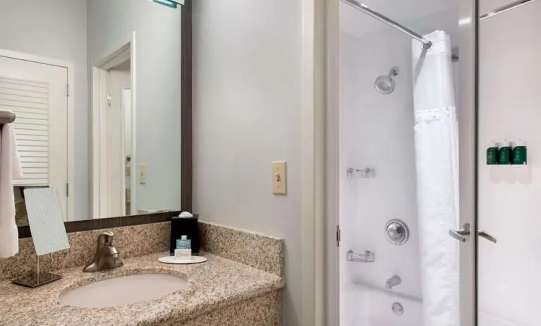 Private guest bathroom with shower and free toiletries at Sonesta Select Newport Middletown.
