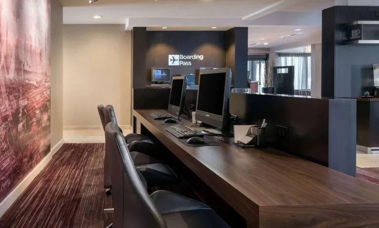 Business center with computers, printer and ergonomic chairs at Sonesta Select Los Angeles LAX El Segundo.