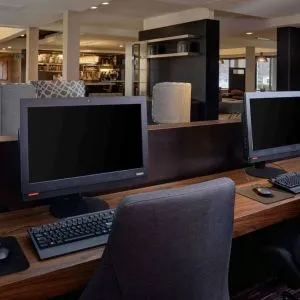 Business center with computers, printer and ergonomic chair at Sonesta Select Kansas City South Overland Park.
