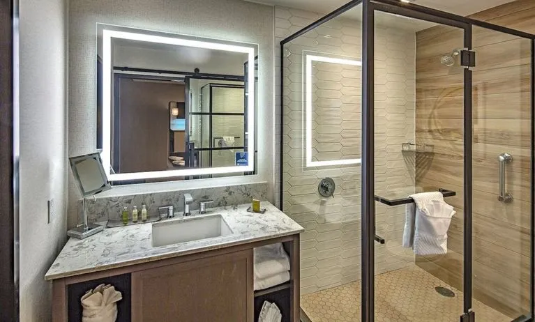 Guest bathroom with shower at DoubleTree By Hilton Modesto.