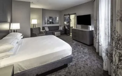 King size bed and sofa in a day use room at DoubleTree By Hilton Modesto.