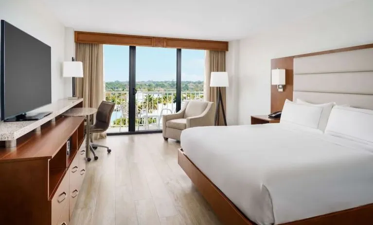 King size bed, work desk and balcony at DoubleTree Beach Resort By Hilton Tampa Bay - North Redington.
