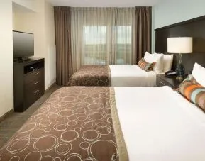 Day use twin room with floor to ceiling window at Sonesta ES Suites Dallas Las Colinas.