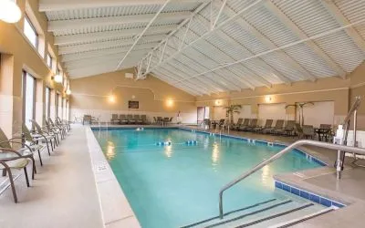 Refreshing indoor pool surrounded by loungers at DoubleTree By Hilton Grand Rapids Airport.