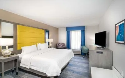 King size bed with work desk at Hampton Inn & Suites Amelia Island-Historic Harbor Front.