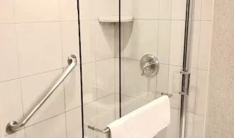 Guest bathroom with shower at DoubleTree By Hilton Lisle-Naperville.