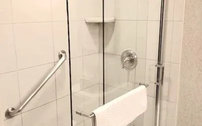 Guest bathroom with shower at DoubleTree By Hilton Lisle-Naperville.