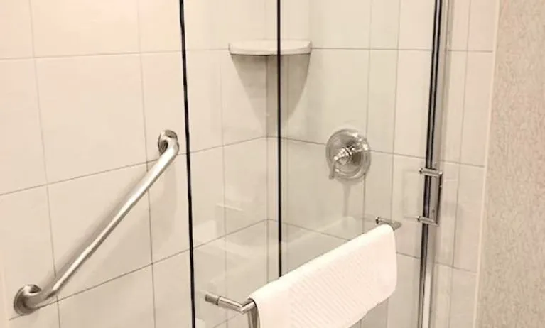 Guest bathroom with shower at DoubleTree By Hilton Lisle-Naperville.