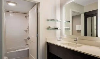 Private guest bathroom with combined shower and tub at Sonesta ES Suites Parsippany Morris Plains.