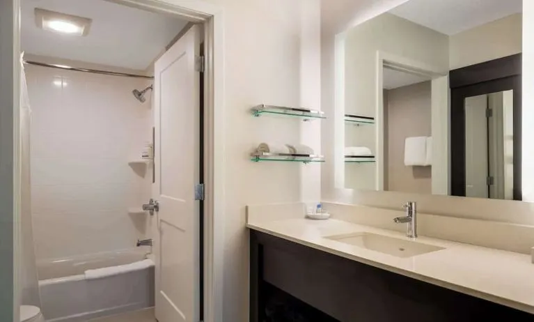 Private guest bathroom with combined shower and tub at Sonesta ES Suites Parsippany Morris Plains.
