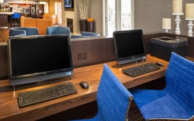 Business center with computers and ergonomic chairs at Sonesta Select Tinton Falls Eatontown.